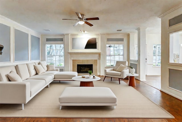 living room with hardwood / wood-style flooring, a wealth of natural light, ornate columns, and ceiling fan