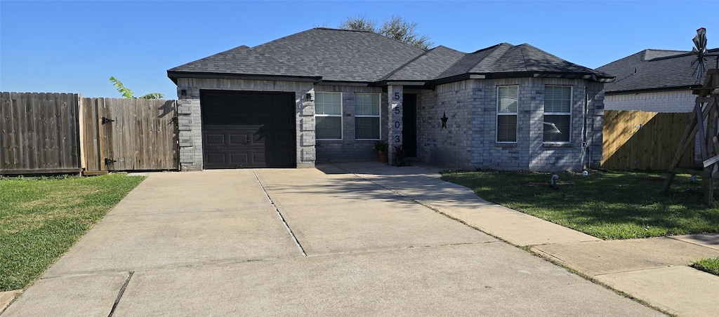 view of front of house with a front yard and a garage