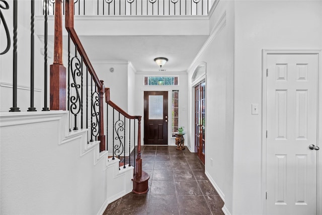 entryway featuring crown molding