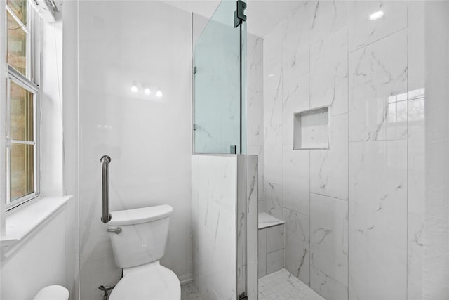 bathroom with tiled shower, a healthy amount of sunlight, and toilet