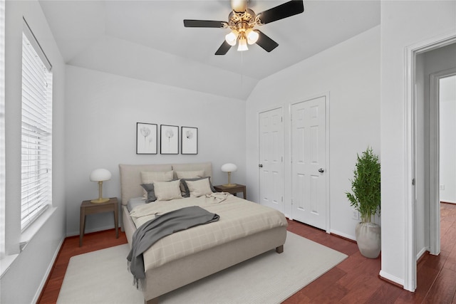 bedroom featuring lofted ceiling, dark wood-type flooring, and ceiling fan