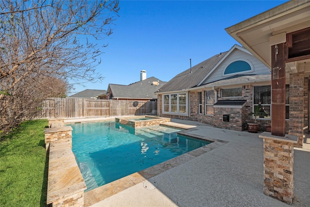 view of swimming pool with an in ground hot tub and a patio