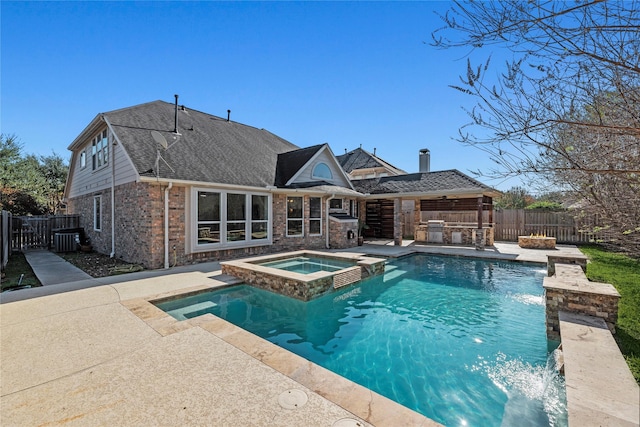 view of pool featuring an in ground hot tub, pool water feature, and a patio area