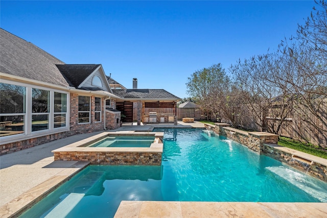 view of pool with a patio area, pool water feature, and an in ground hot tub