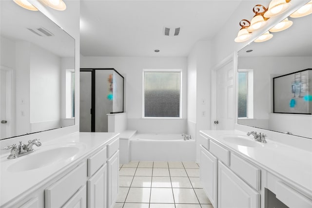 bathroom with tile patterned floors, shower with separate bathtub, and vanity