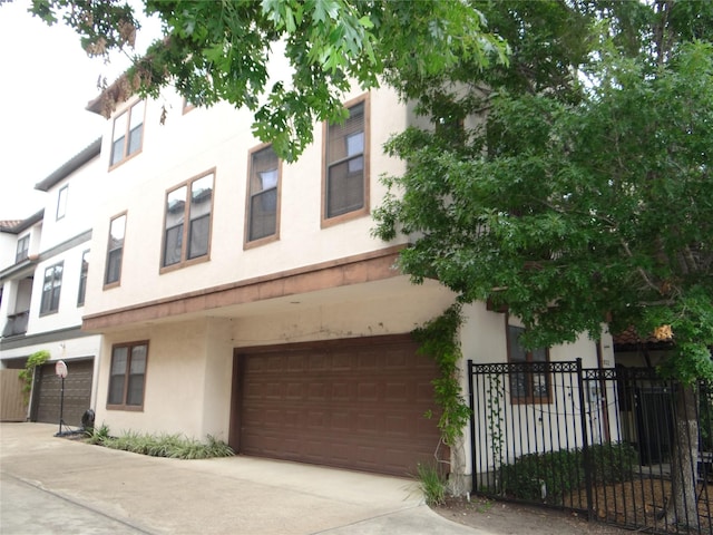 3932 Feagan St, Houston, TX 77007 - view of front of property with stucco siding, an attached garage, and driveway