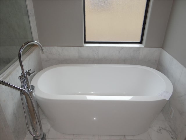 3932 Feagan St, Houston, TX 77007 - bathroom with marble finish floors, tile walls, and a soaking tub