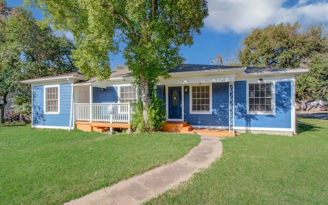 view of front facade with covered porch and a front lawn