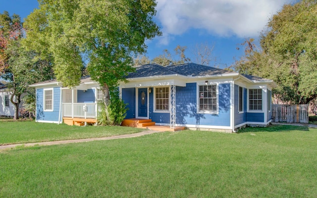 ranch-style home with a porch and a front yard