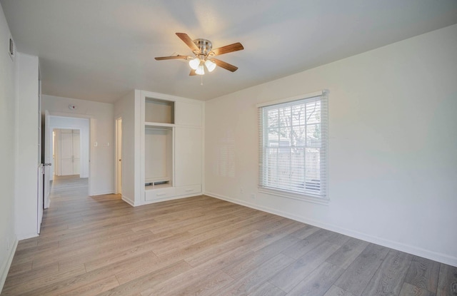 unfurnished bedroom with ceiling fan, light wood-type flooring, and a closet