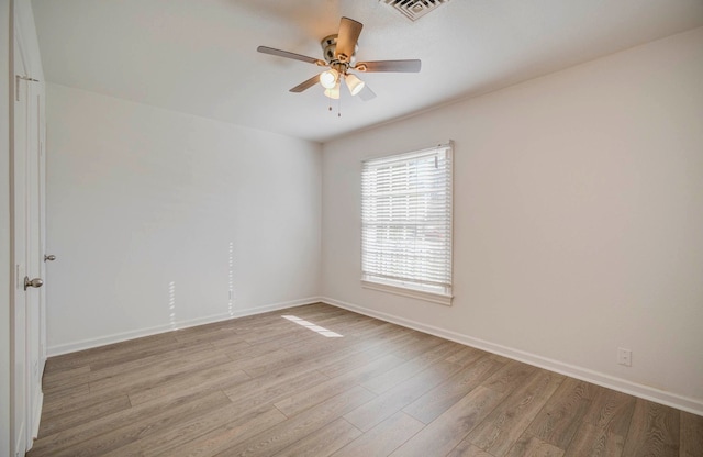 unfurnished room with ceiling fan and light wood-type flooring