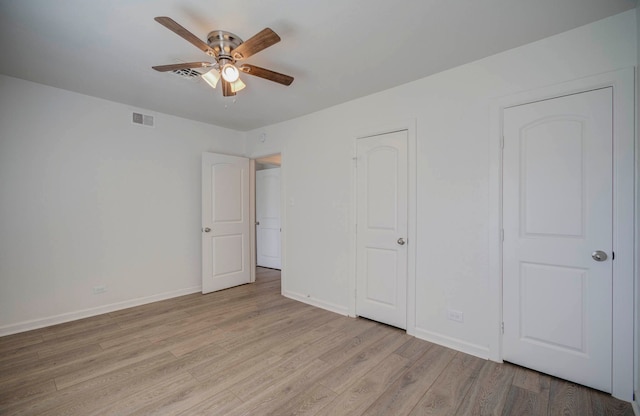 unfurnished bedroom with ceiling fan and light hardwood / wood-style floors