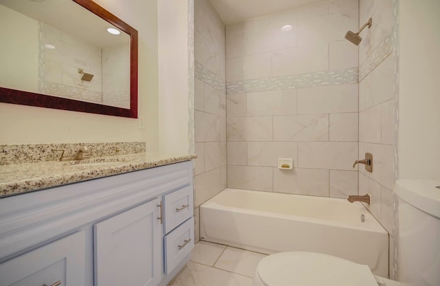 full bathroom featuring vanity, tiled shower / bath combo, and toilet