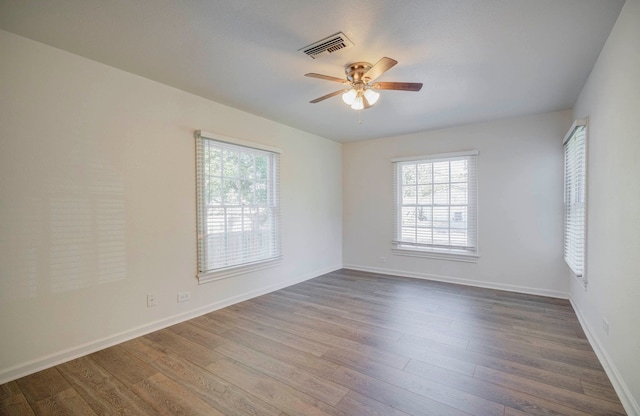 spare room with ceiling fan and hardwood / wood-style floors