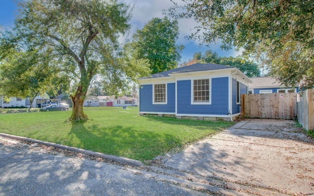 view of side of property with a yard