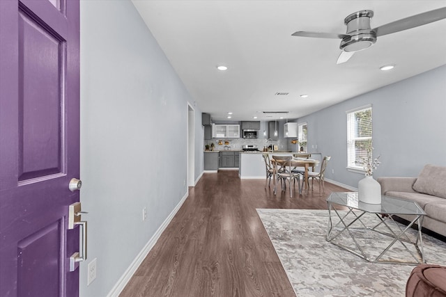 living room with ceiling fan and hardwood / wood-style flooring