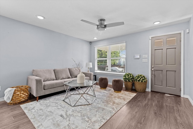 living room featuring dark hardwood / wood-style floors and ceiling fan