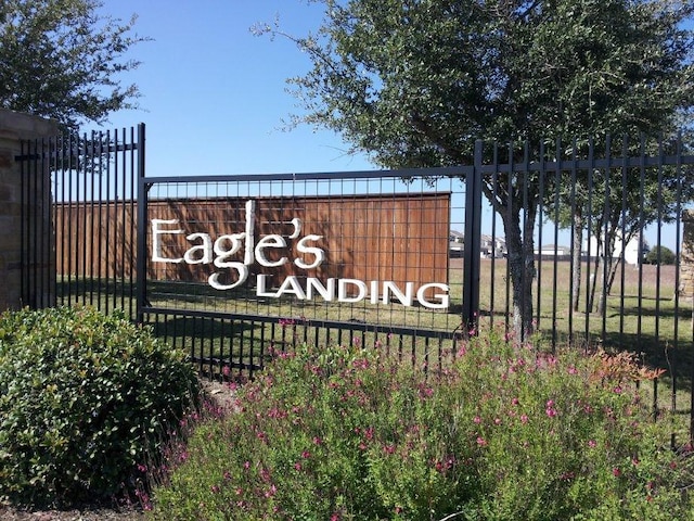 community sign featuring fence