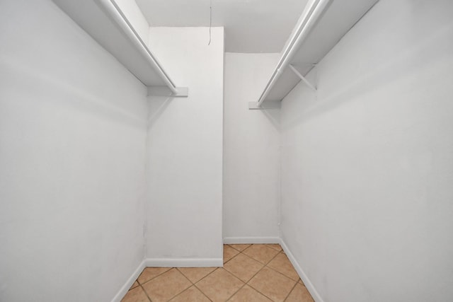 spacious closet with light tile patterned floors