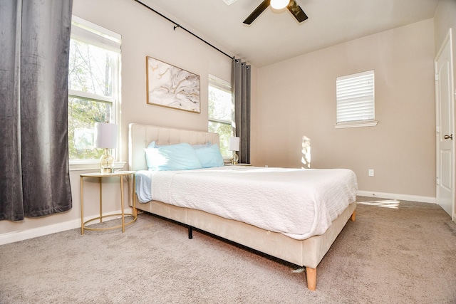 bedroom featuring multiple windows, carpet, and ceiling fan