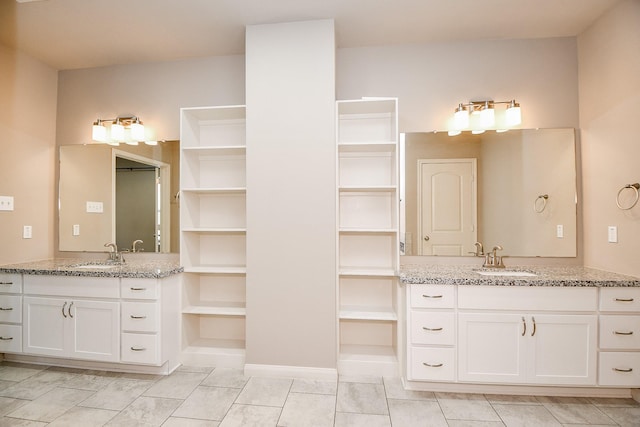 bathroom featuring tile patterned flooring and vanity