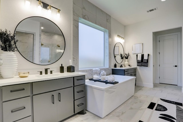 bathroom with vanity, a healthy amount of sunlight, and a bath