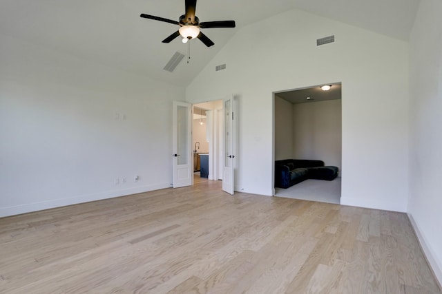 empty room with light hardwood / wood-style floors, high vaulted ceiling, and ceiling fan