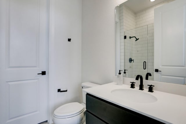 bathroom featuring vanity, toilet, and an enclosed shower