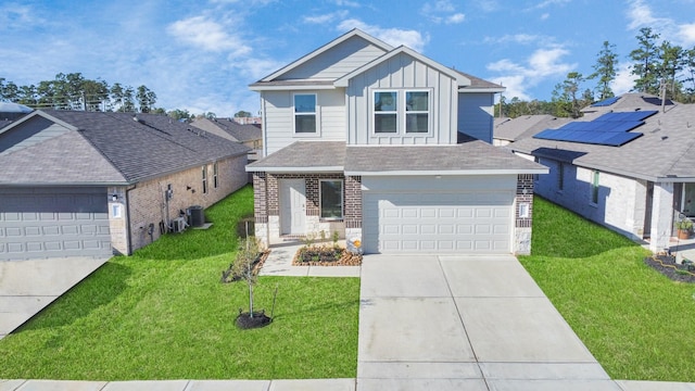 view of front property with a garage, central air condition unit, and a front yard