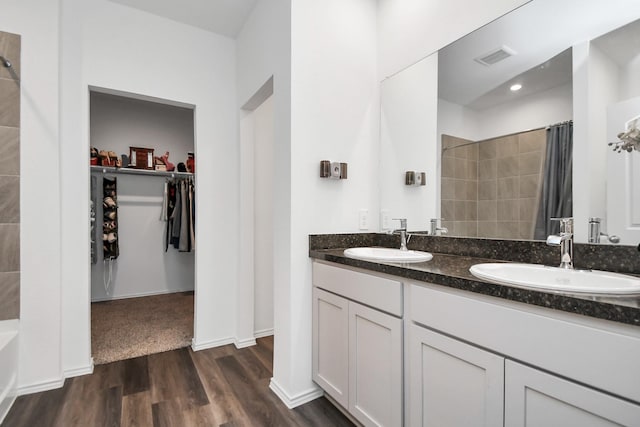 bathroom with a shower with shower curtain, vanity, and hardwood / wood-style flooring