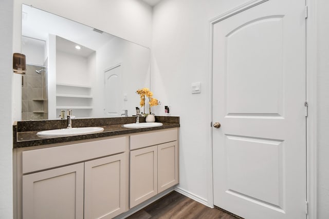 bathroom featuring a shower, hardwood / wood-style floors, and vanity