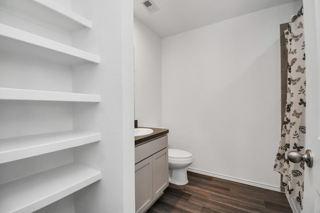 bathroom with hardwood / wood-style flooring, vanity, and toilet