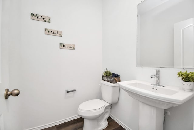 bathroom featuring hardwood / wood-style flooring, sink, and toilet