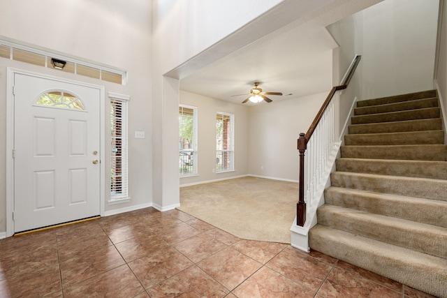 carpeted entrance foyer with ceiling fan