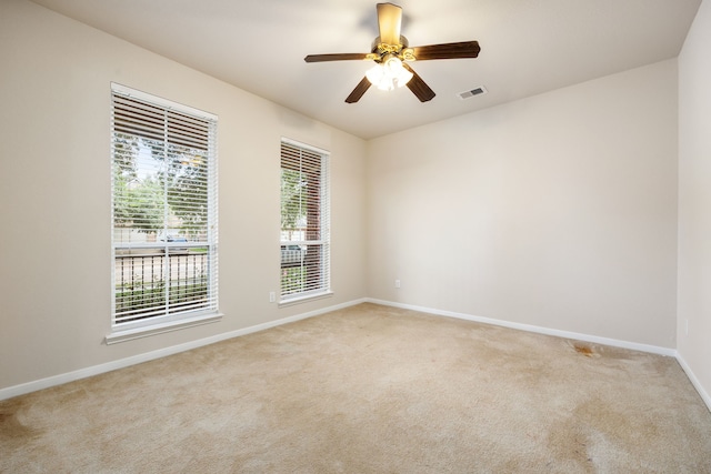 carpeted empty room featuring ceiling fan