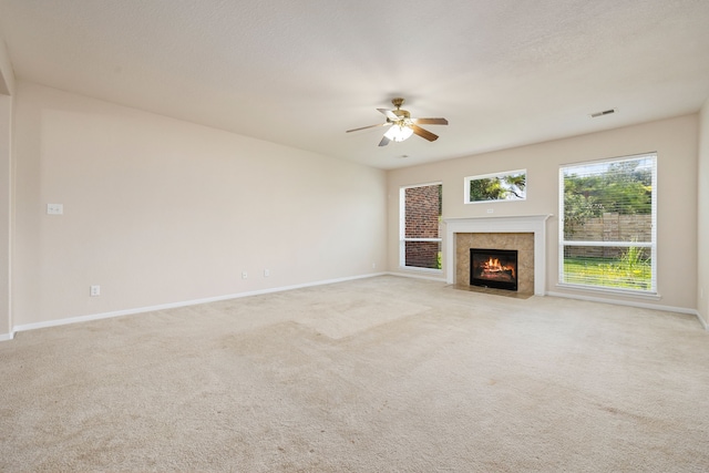 unfurnished living room with ceiling fan and light colored carpet