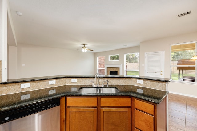 kitchen featuring dishwasher, ceiling fan, a wealth of natural light, and sink