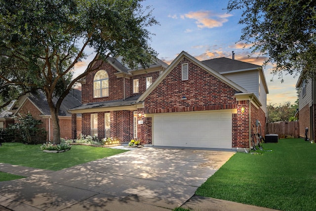 view of property with a lawn and a garage