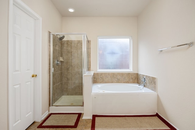 bathroom featuring plus walk in shower and tile patterned flooring