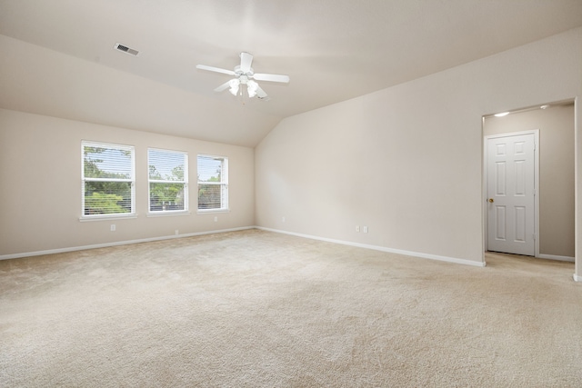 carpeted spare room with ceiling fan and lofted ceiling