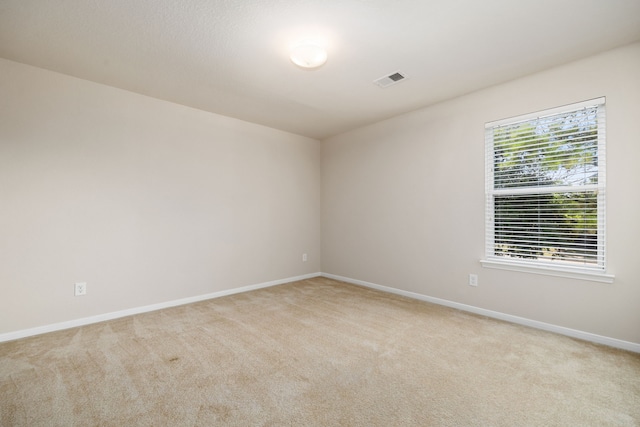 spare room with light carpet