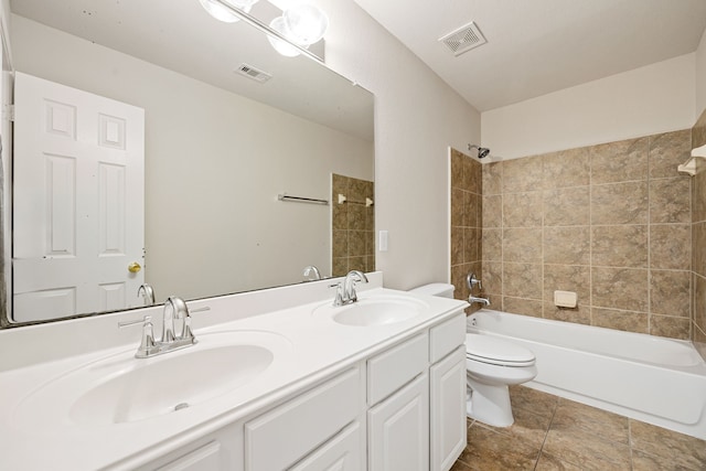 full bathroom with tile patterned floors, vanity, toilet, and tiled shower / bath