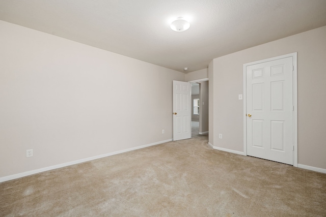 unfurnished bedroom featuring light carpet