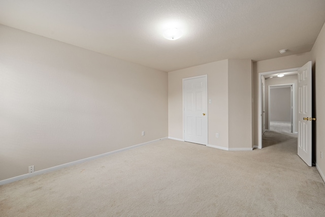 unfurnished bedroom featuring light colored carpet and a closet