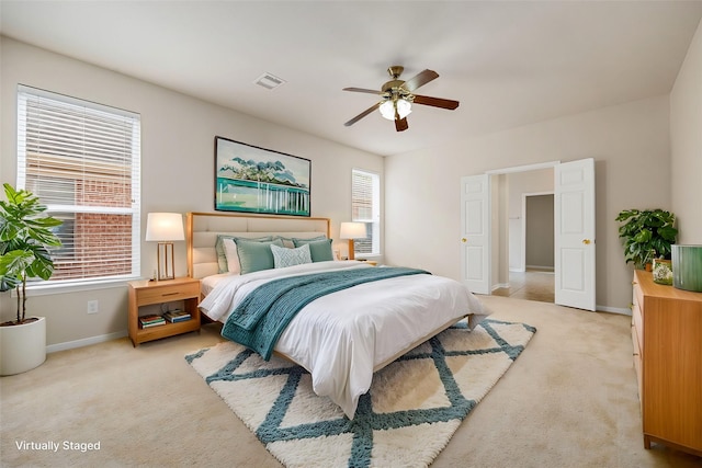 bedroom featuring ceiling fan and light colored carpet