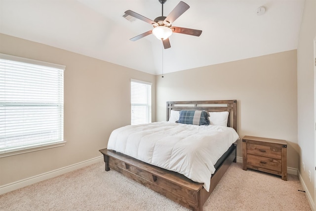 carpeted bedroom with multiple windows, ceiling fan, and lofted ceiling