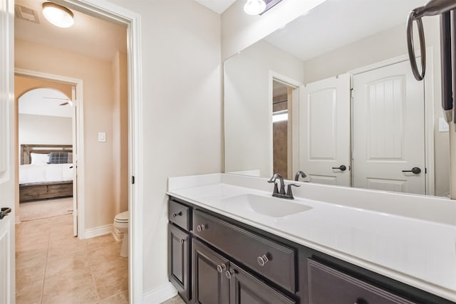 bathroom with tile patterned floors, vanity, and toilet