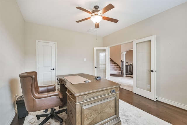 office featuring french doors, dark hardwood / wood-style floors, and ceiling fan