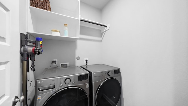 laundry area featuring washing machine and clothes dryer