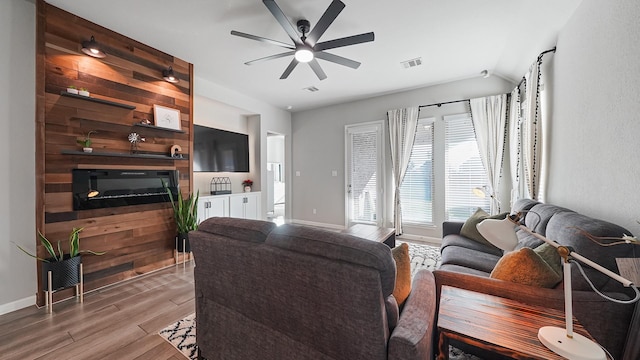 living room featuring ceiling fan and light hardwood / wood-style flooring